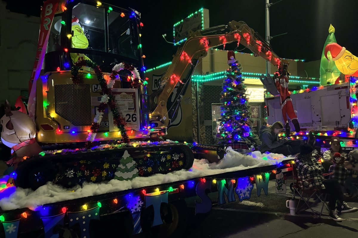 An excavator wrapped in coloured lights as a parade entry